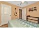 Inviting bedroom with wood floors, neutral walls, guitar decor, and a comfortable patterned bedspread at 16892 Delia St, Wimauma, FL 33598