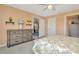 Bedroom featuring neutral paint, a ceiling fan, a dresser, and closet doors at 16892 Delia St, Wimauma, FL 33598