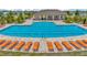 Community pool with lounge chairs and a covered pavilion at the end of the pool at 16892 Delia St, Wimauma, FL 33598