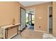 Entryway with tan walls, decorated table, and a glimpse into the screened-in porch at 16892 Delia St, Wimauma, FL 33598