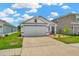 Charming single-story home featuring a two-car garage, well-maintained lawn, long driveway and cute landscaping at 16892 Delia St, Wimauma, FL 33598