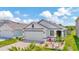 Well-maintained single Gathering home featuring a two car garage and a landscaped front yard at 16892 Delia St, Wimauma, FL 33598
