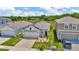 A suburban home with a two-car garage and a well-kept lawn surrounded by green space at 16892 Delia St, Wimauma, FL 33598