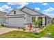 Charming single-story home featuring a two-car garage, well-maintained lawn and decorative front yard landscaping at 16892 Delia St, Wimauma, FL 33598
