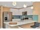 Bright kitchen features stainless steel appliances, white cabinets, breakfast bar and decorative lighting at 16892 Delia St, Wimauma, FL 33598