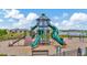 View of a colorful playground with slides and climbing structures near a lake at 16892 Delia St, Wimauma, FL 33598