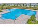 Large swimming pool with multiple lanes and lounge seating in a community setting at 16892 Delia St, Wimauma, FL 33598