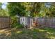 Fenced backyard with a storage shed and vibrant foliage adding to the outdoor ambiance at 1726 York S St, Gulfport, FL 33707