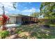 Spacious backyard featuring a screened lanai and fire pit, perfect for outdoor relaxation and entertainment at 1726 York S St, Gulfport, FL 33707