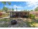 Expansive backyard featuring a screened lanai and fire pit, perfect for outdoor relaxation and entertainment at 1726 York S St, Gulfport, FL 33707
