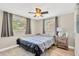 Bright bedroom with wood floors, ceiling fan and comfortable queen bed and window for natural lighting at 1726 York S St, Gulfport, FL 33707