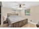 Bright bedroom featuring a wooden bed frame, ceiling fan and two windows for natural lighting at 1726 York S St, Gulfport, FL 33707
