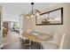 Cozy dining room with stylish light fixture, neutral walls, decorative mirror, and access to the living room at 1726 York S St, Gulfport, FL 33707