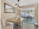 Bright dining area with a modern light fixture, sliding glass doors to the patio, and neutral decor at 1726 York S St, Gulfport, FL 33707