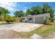 Charming house features stone accents, a well-maintained yard, and a driveway leading to an attached garage at 1726 York S St, Gulfport, FL 33707