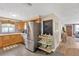 Modern kitchen with stainless steel appliances, bright countertops, wood cabinets, and open layout to living area at 1726 York S St, Gulfport, FL 33707