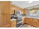 Well-equipped kitchen with stainless steel appliances, tile backsplash, marble countertops, and shaker cabinets at 1726 York S St, Gulfport, FL 33707