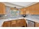 Well-lit kitchen with stylish backsplash, quartz countertops, stainless steel appliances, and wooden cabinets at 1726 York S St, Gulfport, FL 33707