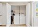 Convenient laundry area with a washer, dryer, storage shelves, and easy access to the outdoors at 1726 York S St, Gulfport, FL 33707