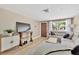 Inviting living room with modern furniture, brick accent wall, wood-look flooring, and bright natural light at 1726 York S St, Gulfport, FL 33707