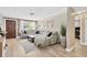 Spacious living room features modern sectional sofa, neutral paint, brick accent wall and ample natural light at 1726 York S St, Gulfport, FL 33707