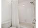 Bathroom featuring a shower and bath combination with white tile and a shower curtain at 19106 Beckett Dr, Odessa, FL 33556