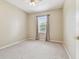 Bedroom with neutral walls, carpet, and a window bringing in natural light at 19106 Beckett Dr, Odessa, FL 33556