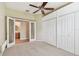 Bedroom featuring an ensuite bathroom, ceiling fan, and a large built-in closet at 19106 Beckett Dr, Odessa, FL 33556