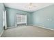 Bright bedroom featuring carpet, ceiling fan, and windows offering abundant natural light at 19106 Beckett Dr, Odessa, FL 33556