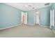 Bedroom with carpet, ceiling fan, and doorway leading to the bathroom at 19106 Beckett Dr, Odessa, FL 33556