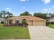 Charming single-story home featuring a well-maintained lawn, two-car garage, and beautiful landscaping at 19106 Beckett Dr, Odessa, FL 33556