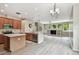 Bright open-concept kitchen with wood cabinets, stainless steel appliances and an open view to the living area at 19106 Beckett Dr, Odessa, FL 33556