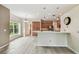 Bright eat-in kitchen with wood cabinets, stainless steel appliances, quartz countertops and wood tile flooring at 19106 Beckett Dr, Odessa, FL 33556