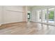 Open living space with light wood floors, access to the lanai, and neutral paint at 19106 Beckett Dr, Odessa, FL 33556