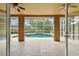 Screened-in lanai overlooking a beautiful pool with a waterfall feature, perfect for relaxation at 19106 Beckett Dr, Odessa, FL 33556