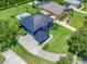 An aerial shot of the house with lush landscaping, a pristine lawn, and a well-manicured driveway at 19620 Eagle Crest Dr, Lutz, FL 33549