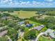 Expansive aerial view of a luxurious estate with a pool, lush landscaping, and a serene rural backdrop at 19620 Eagle Crest Dr, Lutz, FL 33549