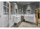 Modern bathroom with double sinks, vanity, and decorative mirrors at 19620 Eagle Crest Dr, Lutz, FL 33549