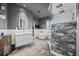 Luxurious bathroom with dual sinks, a freestanding tub, walk-in shower, and stone tile flooring, exuding elegance and modern style at 19620 Eagle Crest Dr, Lutz, FL 33549