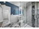 Bathroom with glass enclosed shower, stylish mosaic accent tile, and pedestal sink at 19620 Eagle Crest Dr, Lutz, FL 33549