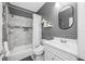 Well-lit bathroom features a shower-tub combination, white sink vanity, and updated decor at 19620 Eagle Crest Dr, Lutz, FL 33549