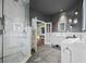 Bathroom featuring a shower, double sinks, and decorative wall planters at 19620 Eagle Crest Dr, Lutz, FL 33549