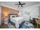 Cozy bedroom featuring a gray bed, unique decor, a ceiling fan and a window with shutters at 19620 Eagle Crest Dr, Lutz, FL 33549