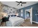 Stylish bedroom featuring a decorative wall, wood floors, and modern ceiling fan at 19620 Eagle Crest Dr, Lutz, FL 33549
