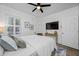 Relaxing bedroom with a comfortable bed, natural light, ceiling fan and television for cozy nights at 19620 Eagle Crest Dr, Lutz, FL 33549