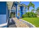 Close up of blue house featuring front entry, manicured landscape, and brick walkway at 19620 Eagle Crest Dr, Lutz, FL 33549