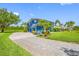 Side view of a bright blue house with lush landscaping and a paved driveway at 19620 Eagle Crest Dr, Lutz, FL 33549