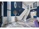 Spacious home foyer featuring marble floors, high ceilings, and a white staircase at 19620 Eagle Crest Dr, Lutz, FL 33549