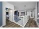 Open hallway featuring hardwood floors, white trim, and contemporary light fixture at 19620 Eagle Crest Dr, Lutz, FL 33549