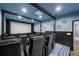 Home theater with a large projector screen, theater seating, custom blue walls, and black accents at 19620 Eagle Crest Dr, Lutz, FL 33549